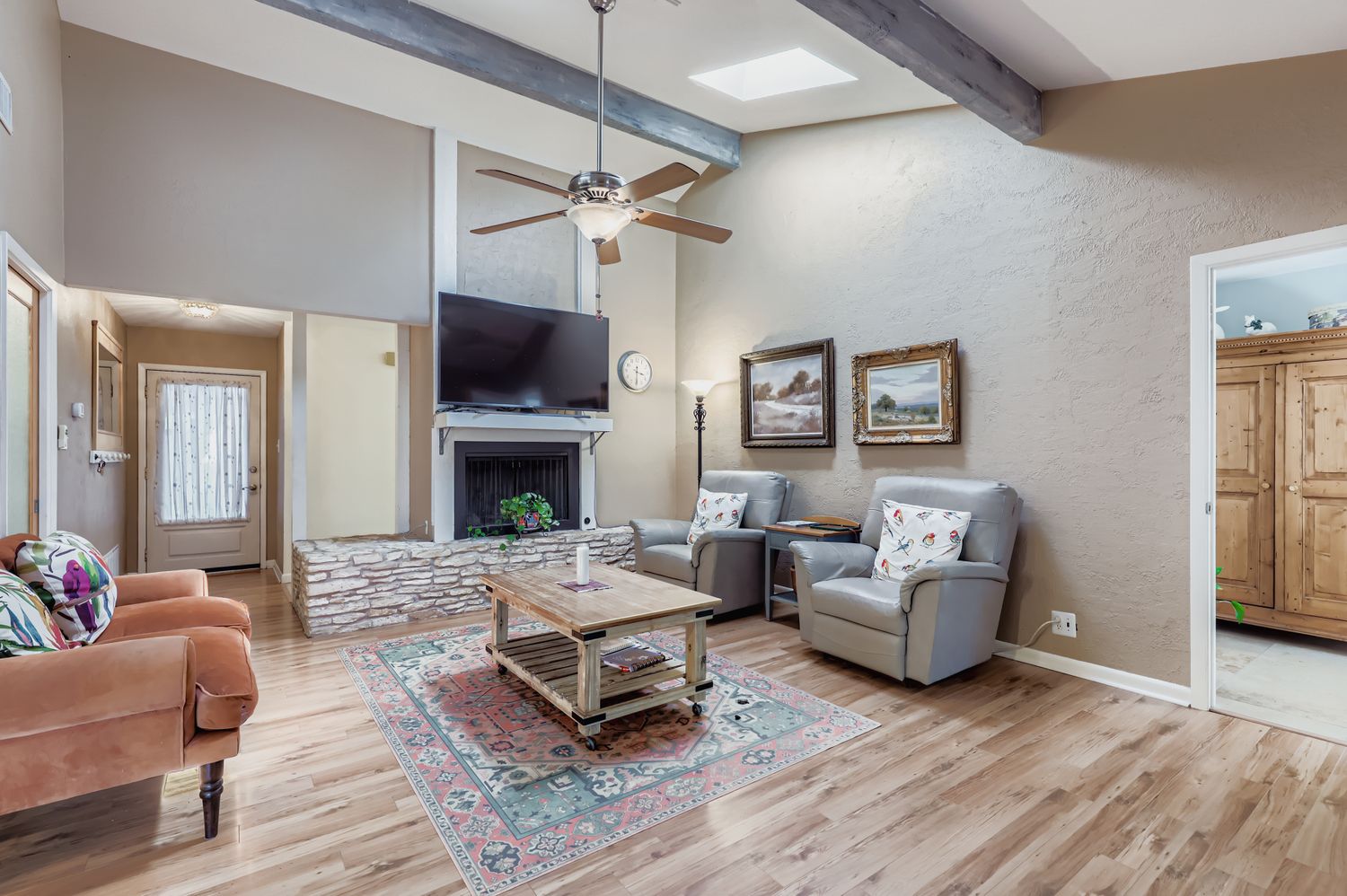 11718 Running Fox Trail Austin, TX 78759 - Photo 8 of 30 a living room with furniture a flat screen tv and a fireplace