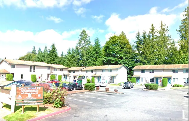 a view of a patio with a table and chairs under an umbrella