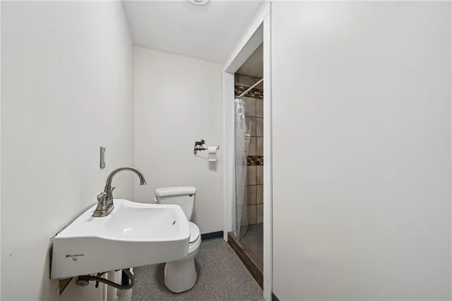 a view of a livingroom with wooden floor and windows