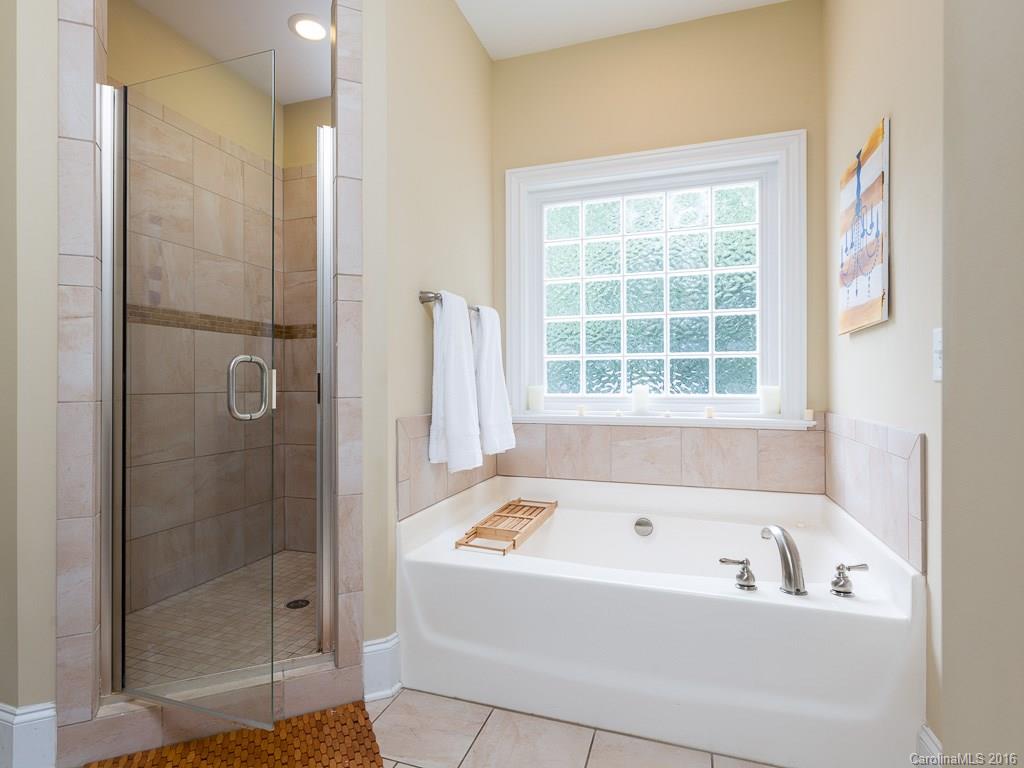 919 Millbrook Road Charlotte, NC 28211 - Photo 11 of 20 a bathroom with a bathtub and shower