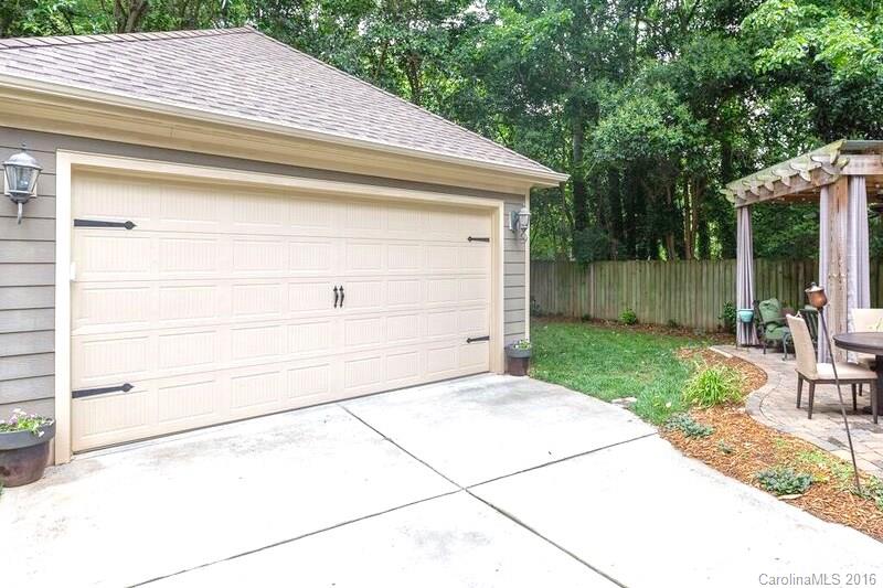 919 Millbrook Road Charlotte, NC 28211 - Photo 20 of 20 a backyard of a house with wooden fence and large trees