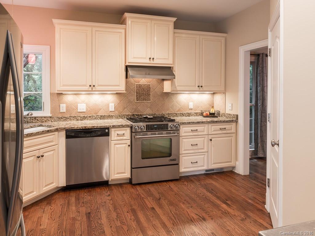 919 Millbrook Road Charlotte, NC 28211 - Photo 4 of 20 a kitchen with granite countertop white cabinets and white appliances