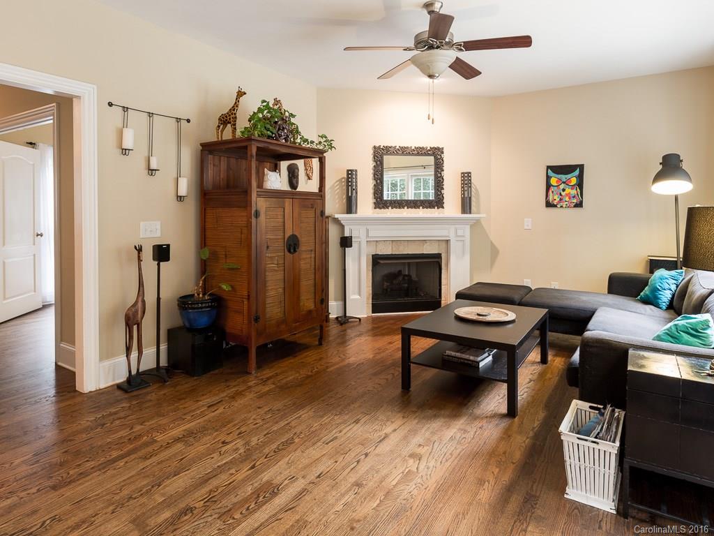 919 Millbrook Road Charlotte, NC 28211 - Photo 5 of 20 a living room with furniture a fireplace and a flat screen tv