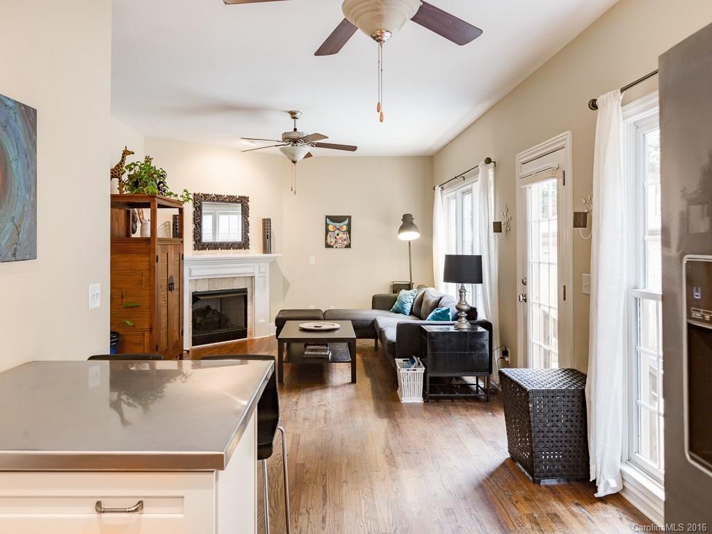 919 Millbrook Road Charlotte, NC 28211 - Photo 6 of 20 a living room with furniture or chandelier and a fireplace