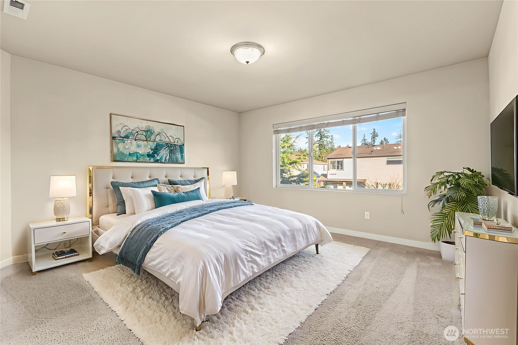 19326 37th Avenue Southeast, Unit C Bothell, WA 98012 - Photo 13 of 32 a bedroom with a large bed and a potted plant