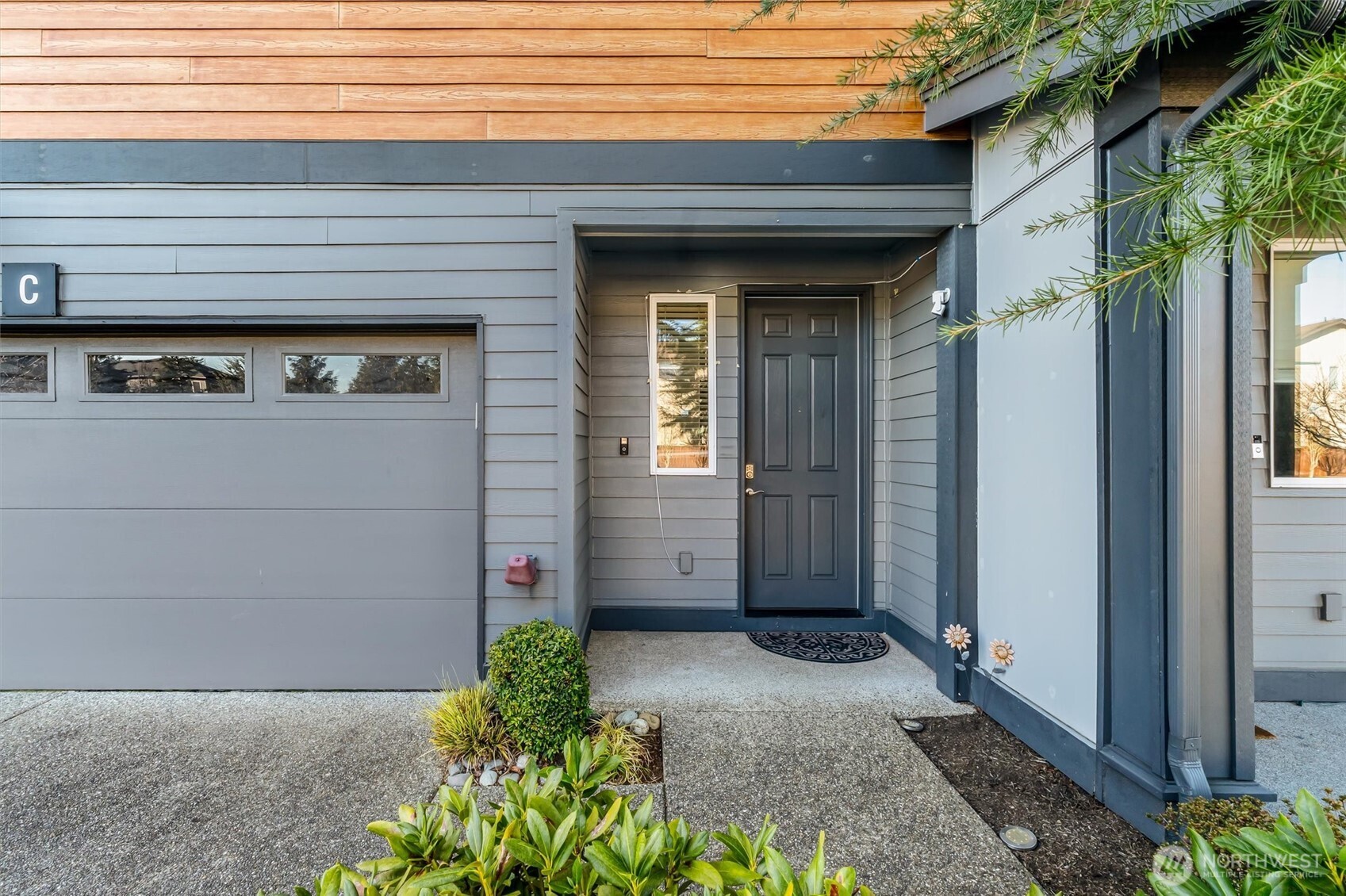 19326 37th Avenue Southeast, Unit C Bothell, WA 98012 - Photo 2 of 32 a view of a brick house with potted plants