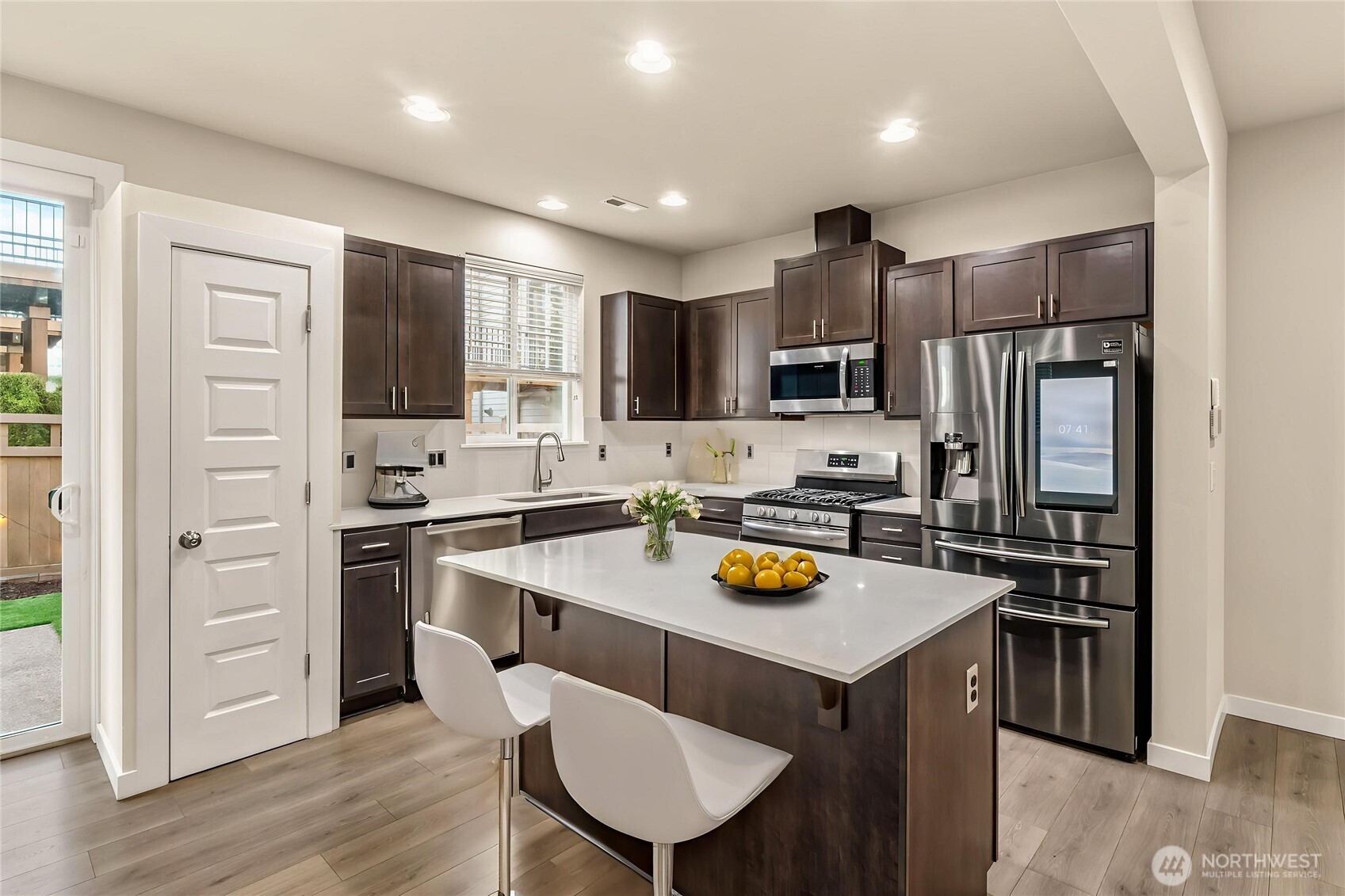 19326 37th Avenue Southeast, Unit C Bothell, WA 98012 - Photo 7 of 32 a kitchen with refrigerator cabinets and wooden floor