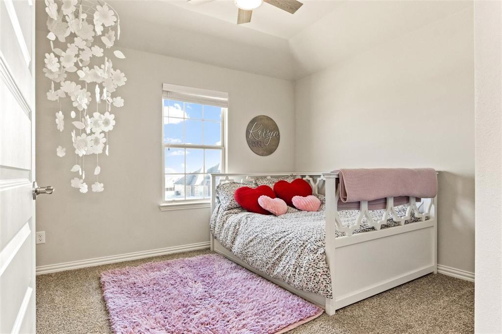1133 Barrix Drive Forney, TX 75126 - Photo 19 of 35 a bedroom with a bed and a window