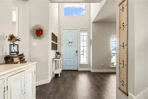 a view of a hallway with wooden floor and workspace