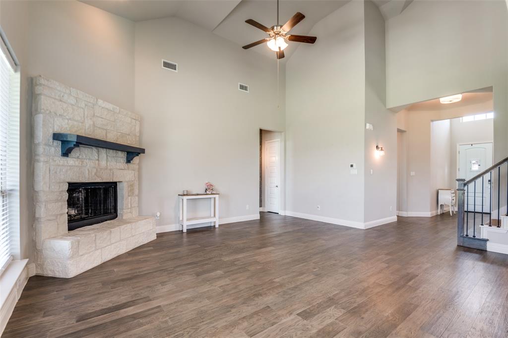 1133 Barrix Drive Forney, TX 75126 - Photo 29 of 35 a view of a livingroom with wooden floor and a kitchen