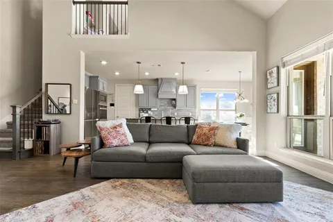 a living room with furniture and a view of kitchen