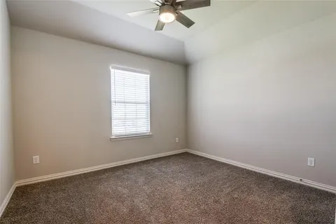 a view of a bedroom with wooden floor