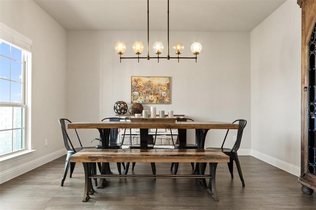 1133 Barrix Drive Forney, TX 75126 - Photo 9 of 35 a view of a dining room with furniture wooden floor and chandelier