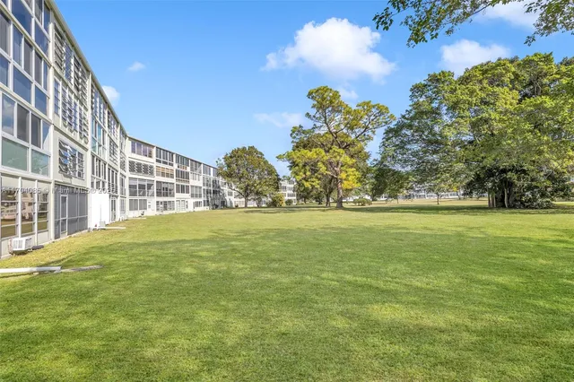 a view of a field with an trees
