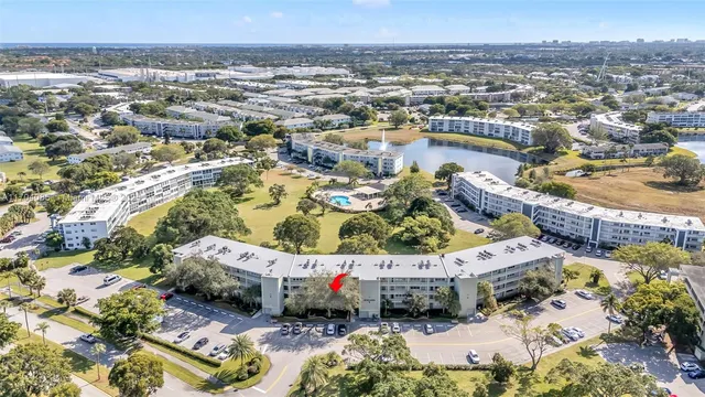 an aerial view of residential houses with outdoor space and ocean view
