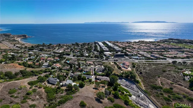 a view of a large body of water with a building in the background