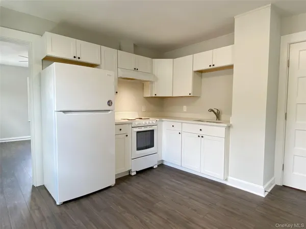 a white refrigerator freezer sitting inside of a kitchen