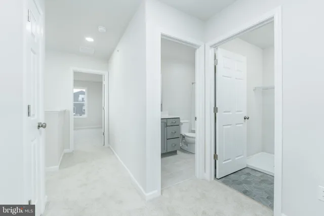 an empty room with windows and entrance