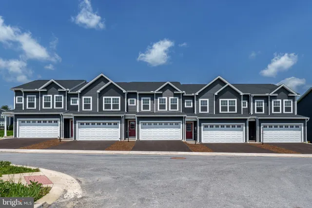 a view of a brick house with large windows