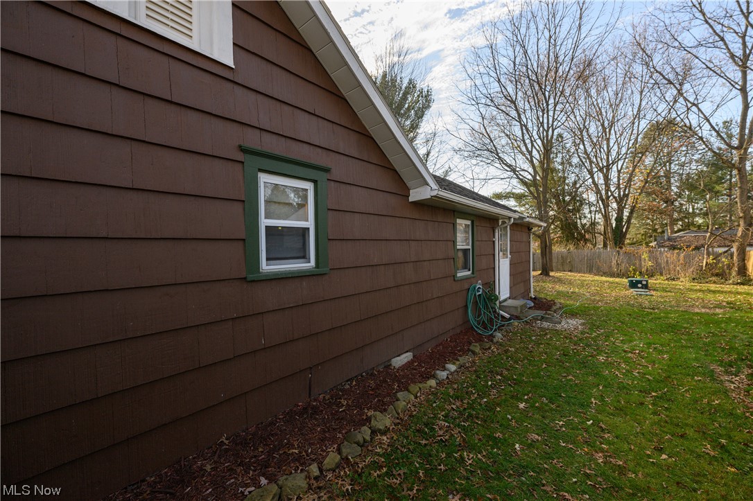 2996 Derling Road Akron, OH 44319 - Photo 4 of 19 View of property exterior featuring a lawn