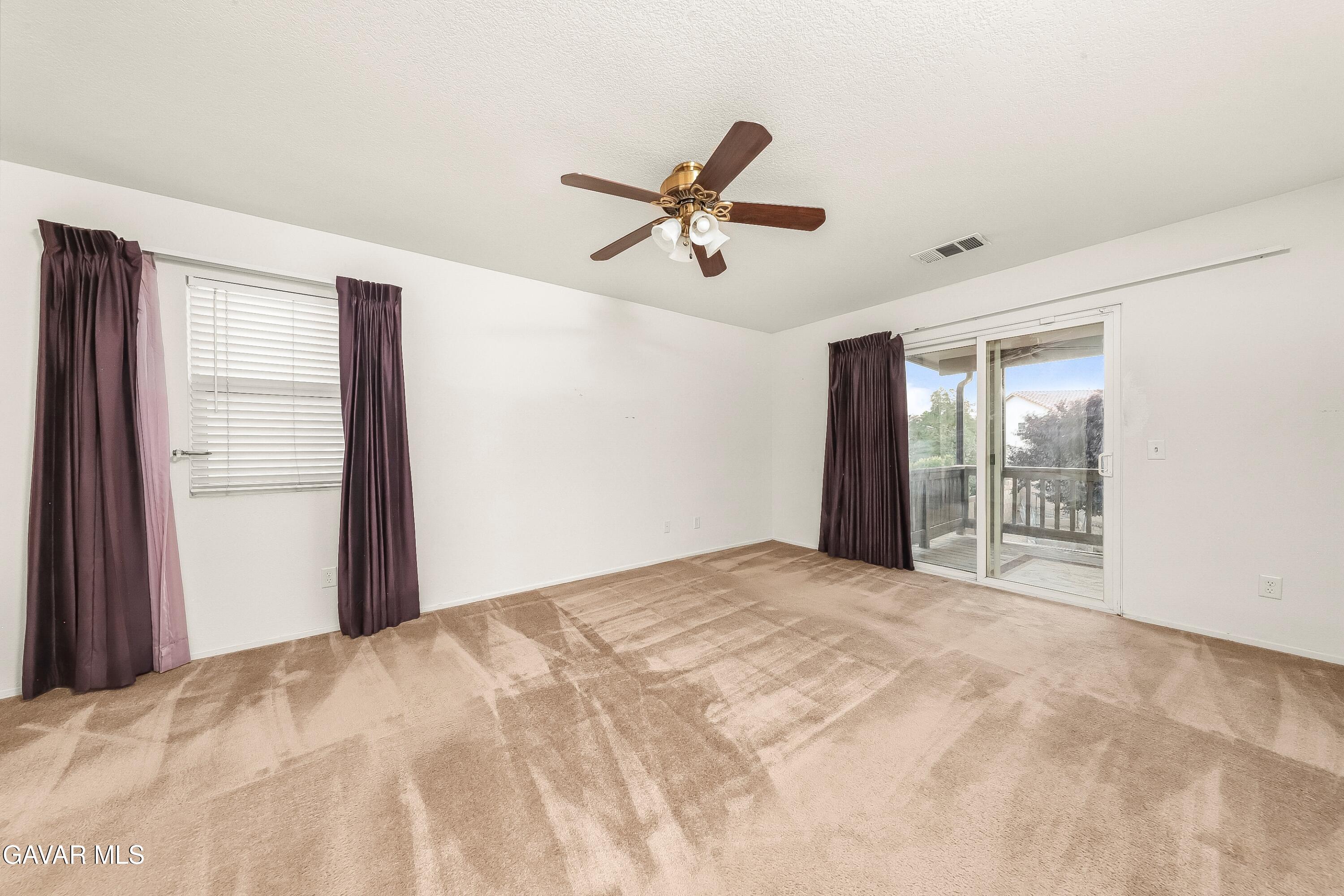 43635 Castle Circle Lancaster, CA 93535 - Photo 37 of 53 a view of a livingroom with a ceiling fan and window