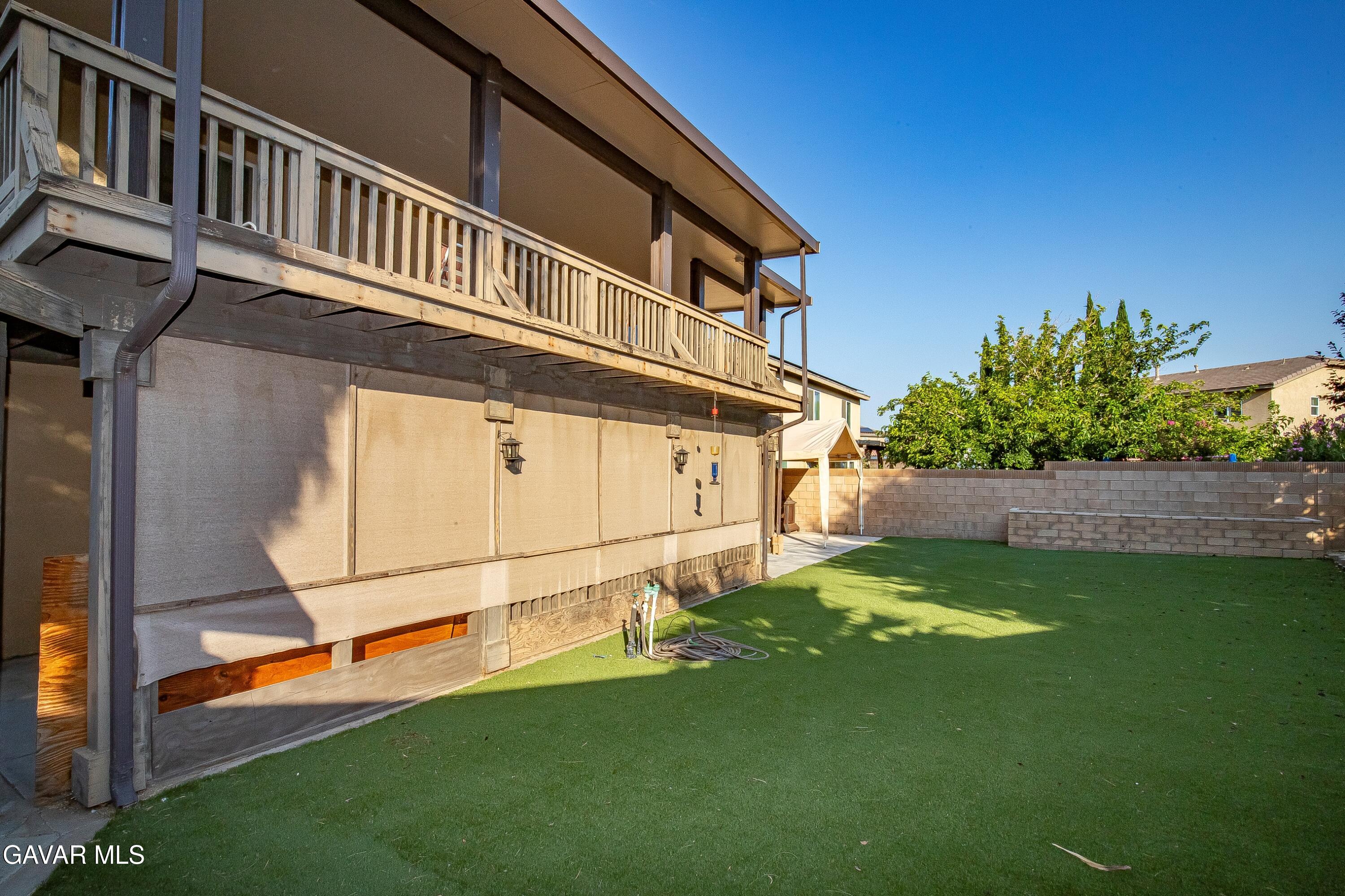 43635 Castle Circle Lancaster, CA 93535 - Photo 38 of 53 a backyard of a house with lots of green space and outdoor seating