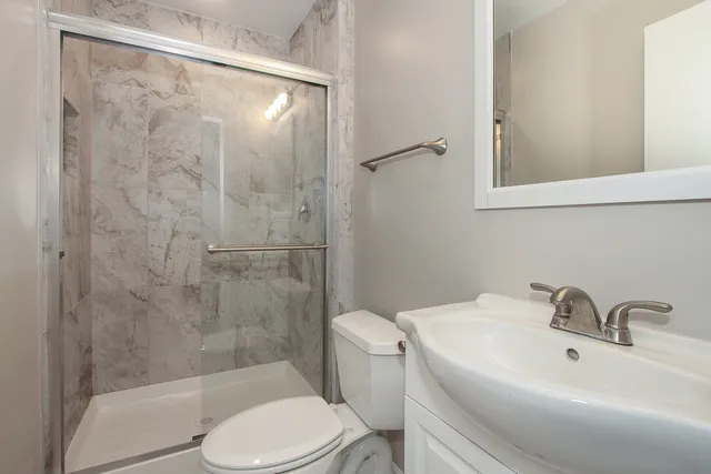 a bathroom with a sink toilet and shower