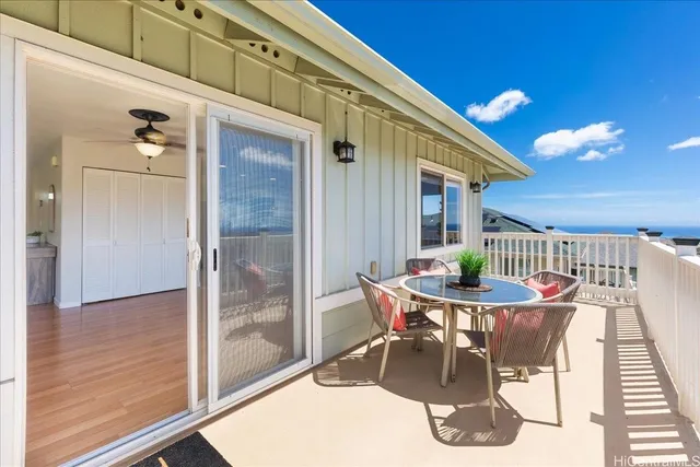 a outdoor dining space with furniture and wooden floor