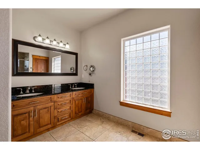 a bathroom with a sink a mirror and a window
