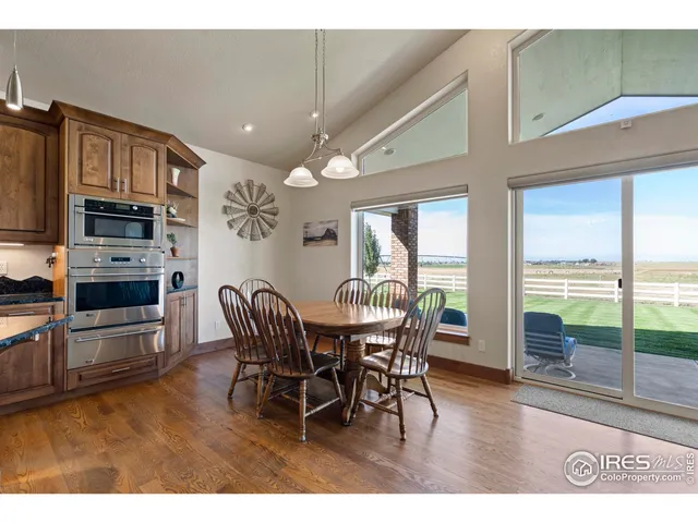 a dining room with furniture and wooden floor