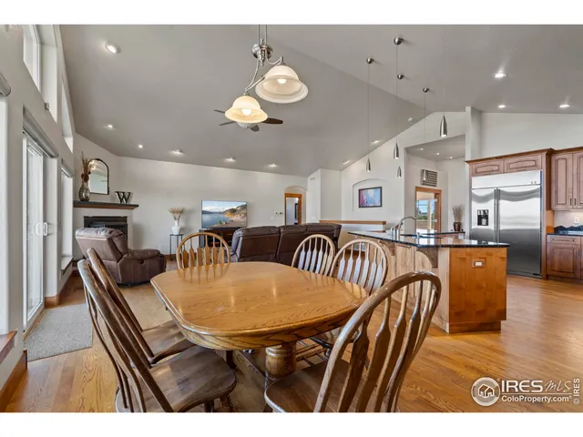 a dining room with furniture and a kitchen view