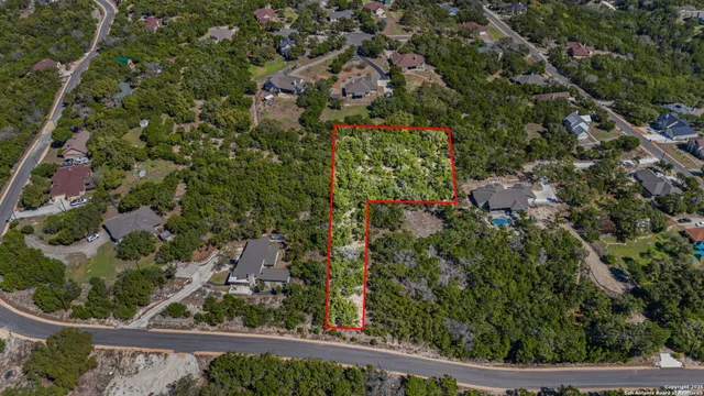a view of green field with trees in the background