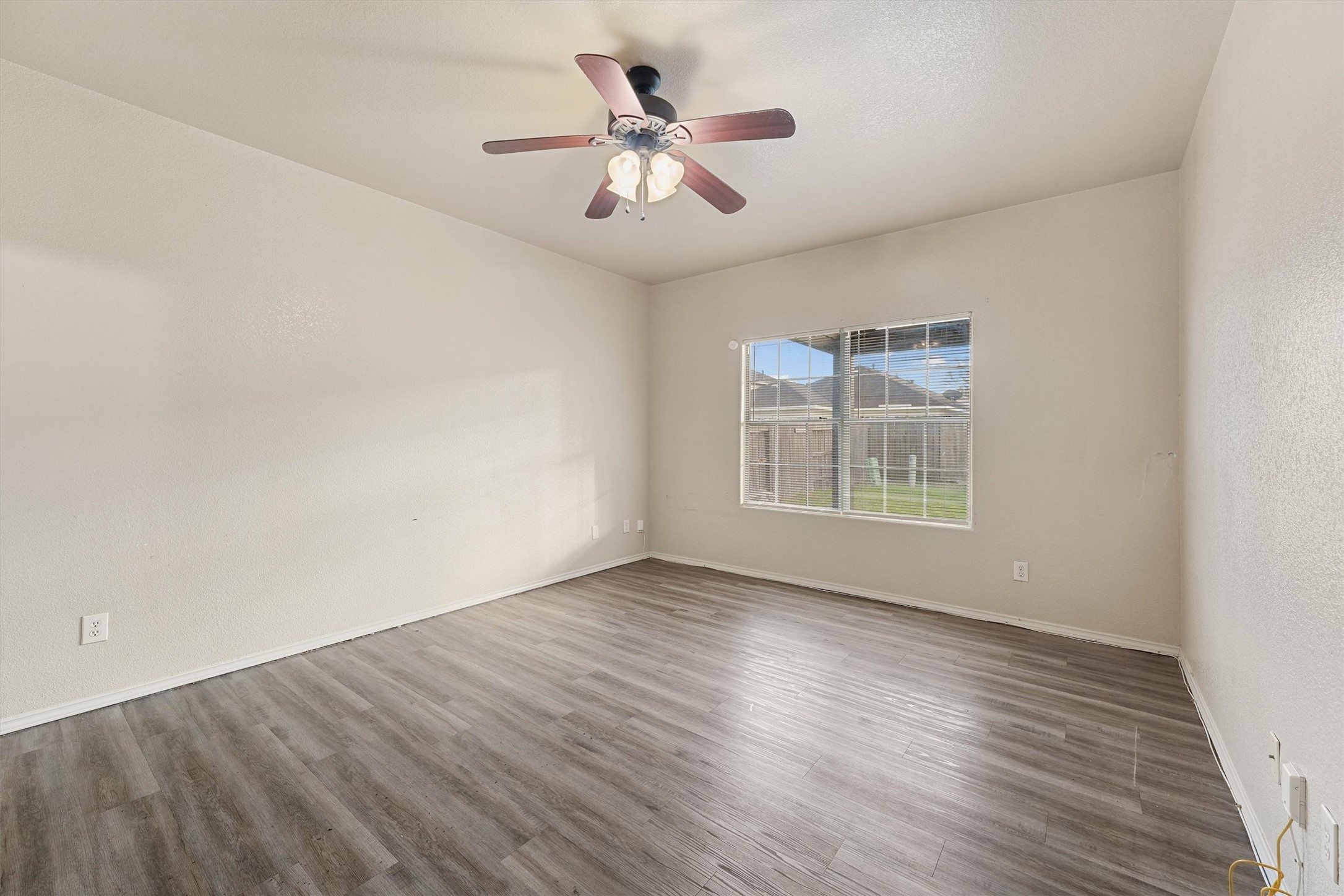 3114 Trinity Joe Lane Humble, TX 77396 - Photo 16 of 28 an empty room with wooden floor chandelier fan and windows