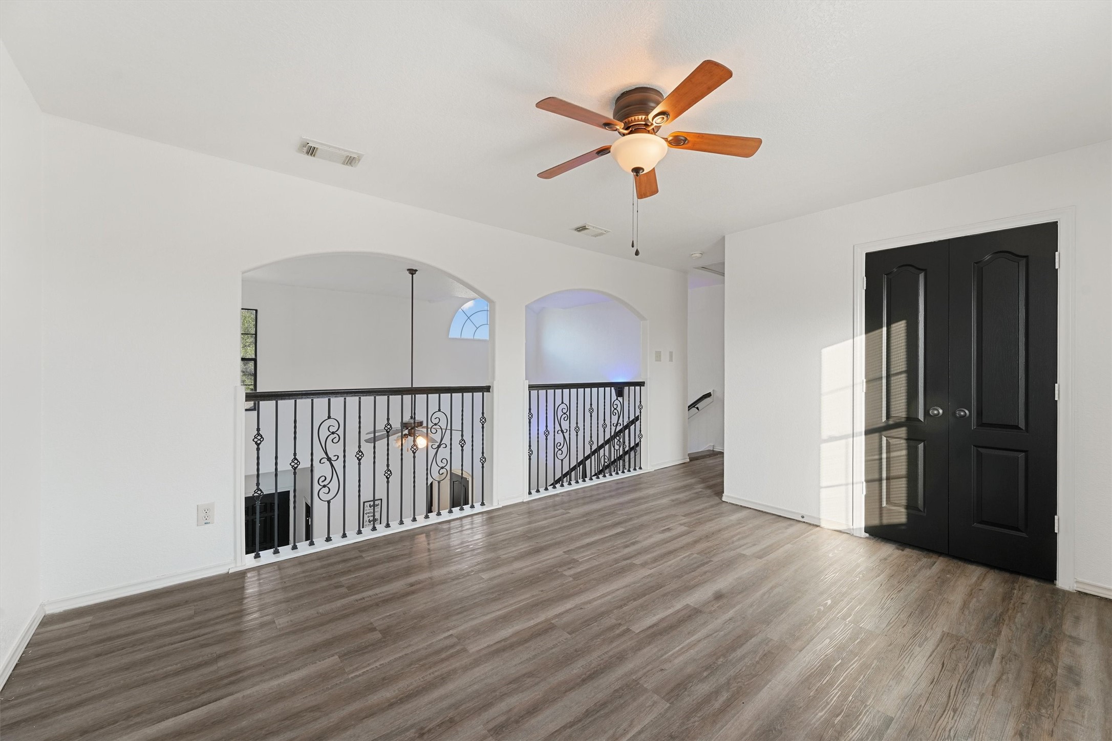 3114 Trinity Joe Lane Humble, TX 77396 - Photo 21 of 28 an empty room with wooden floor fan and windows