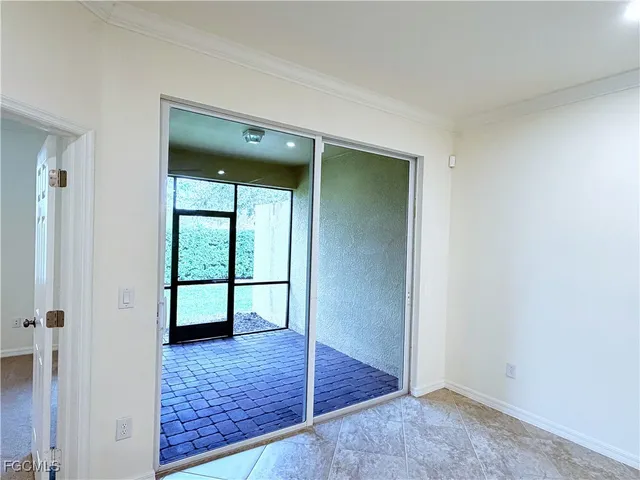 an empty room with window and wooden floor