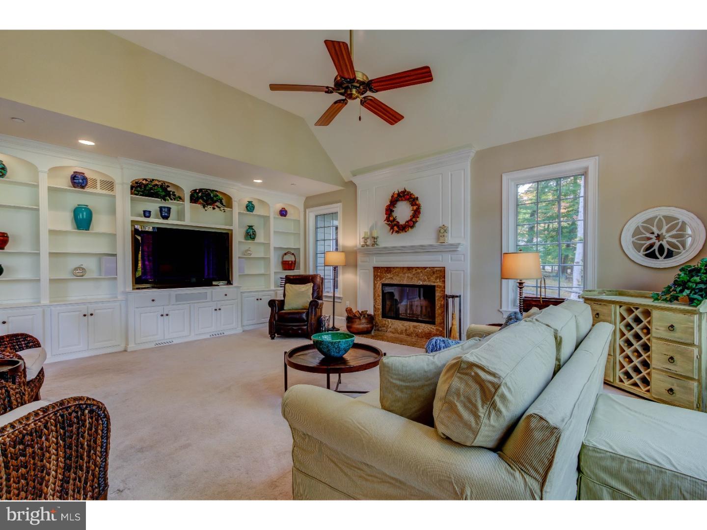 3316 Sawmill Road Newtown Square, PA 19073 - Photo 8 of 24 a living room with furniture a flat screen tv and a fireplace