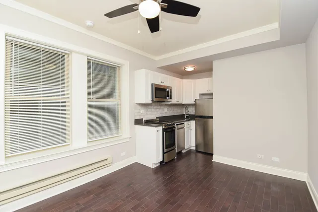 a kitchen with stainless steel appliances granite countertop a stove and a refrigerator