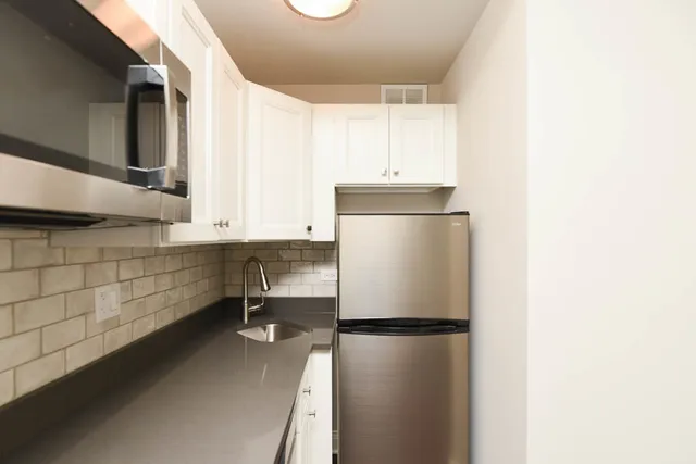 a kitchen with a refrigerator and a cabinets