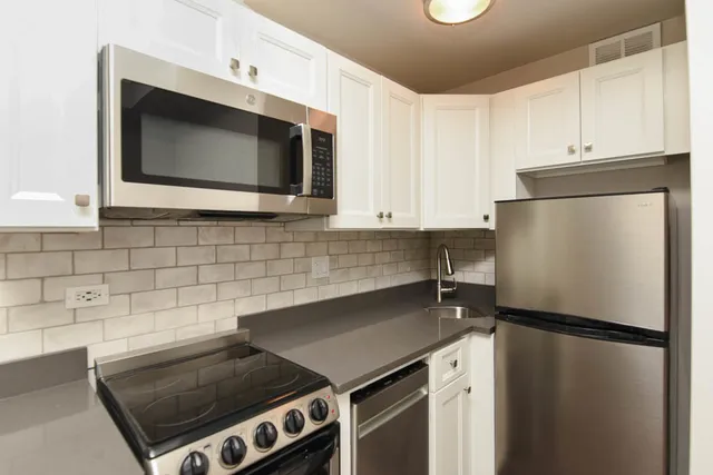 a kitchen with a refrigerator stove and microwave