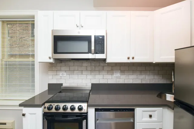 a kitchen with a stove and a microwave