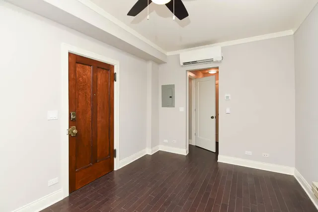 an empty room with wooden floor and closet