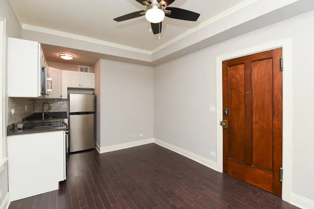 a kitchen with stainless steel appliances a refrigerator and a stove top oven