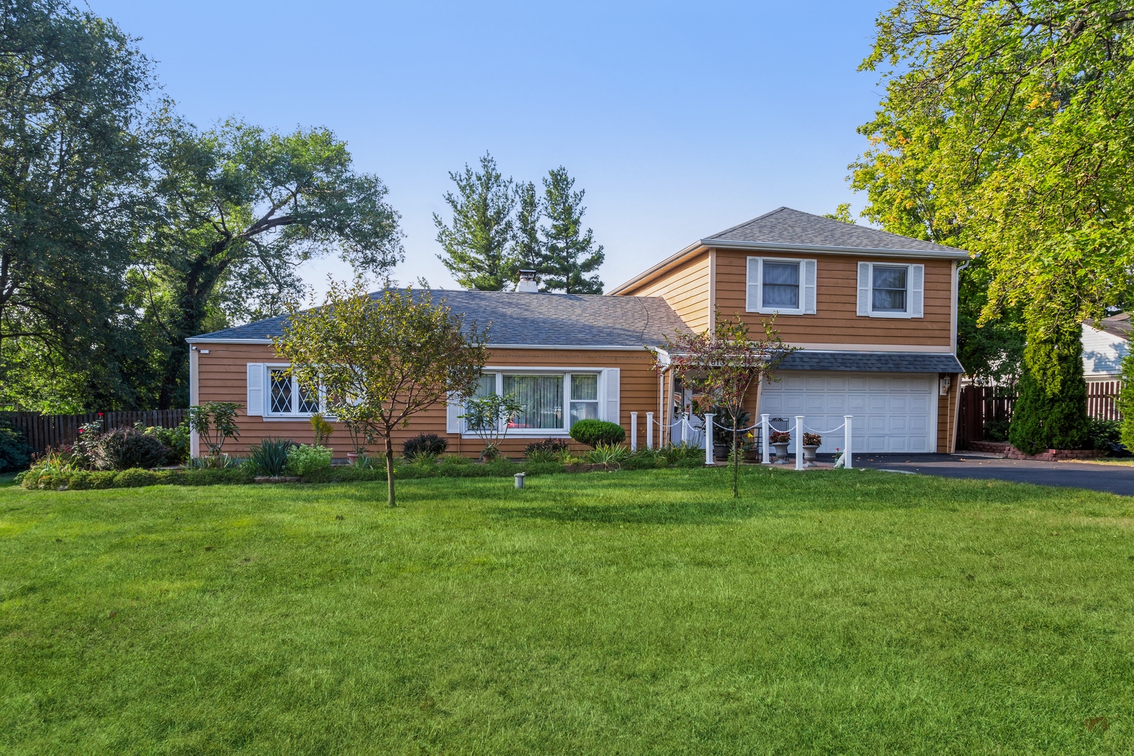 613 West Edgewood Road Lombard, IL 60148 - Photo 1 of 21 a front view of a house with a garden
