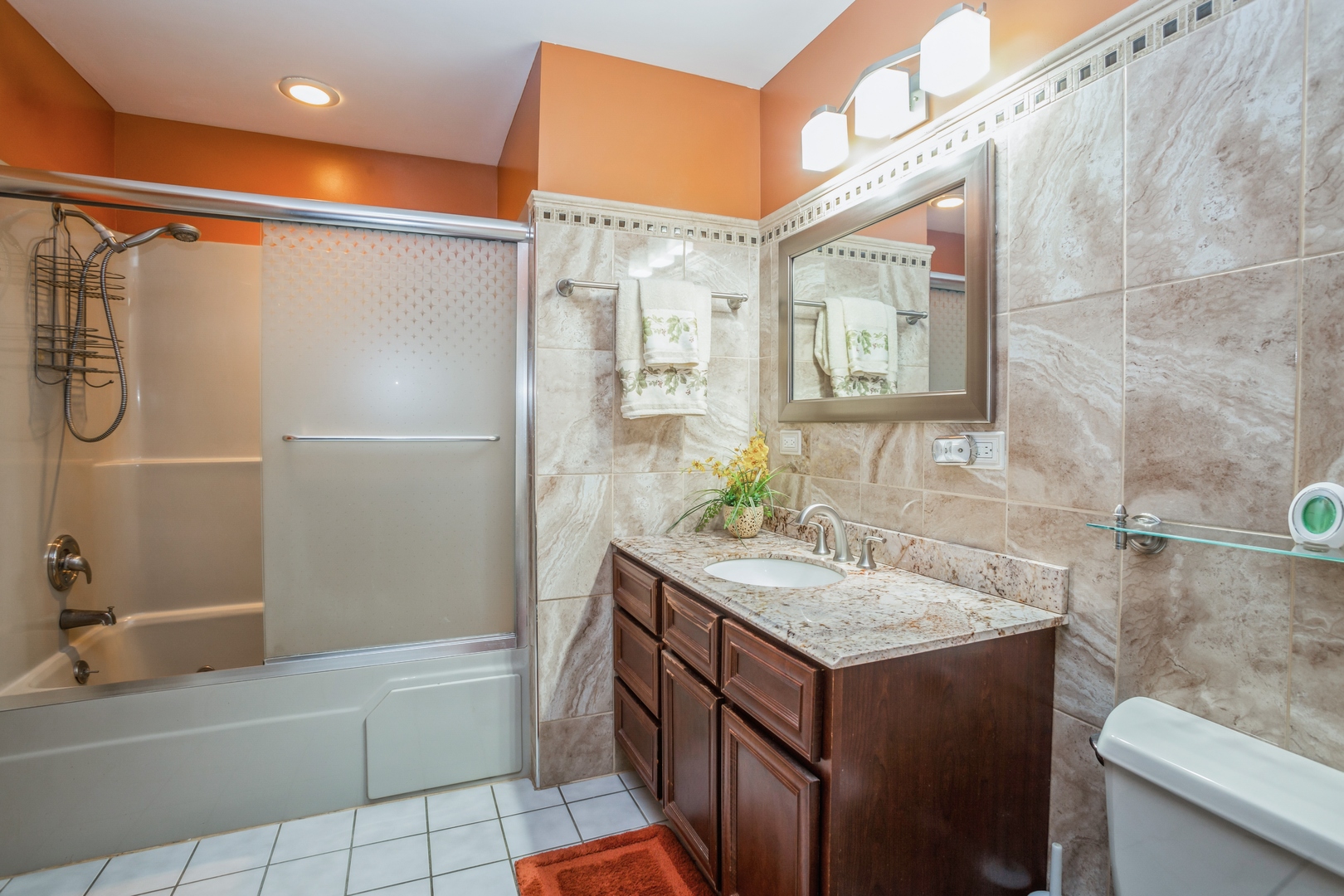 613 West Edgewood Road Lombard, IL 60148 - Photo 15 of 21 a bathroom with a granite countertop sink a mirror and a bathtub