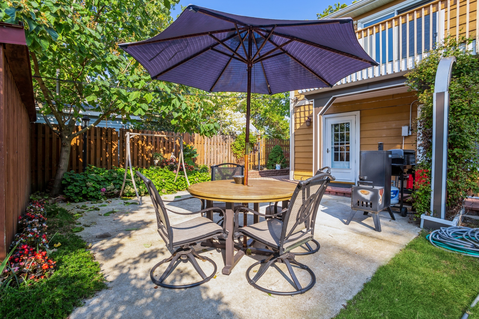 613 West Edgewood Road Lombard, IL 60148 - Photo 19 of 21 a view of a patio with table and chairs under an umbrella