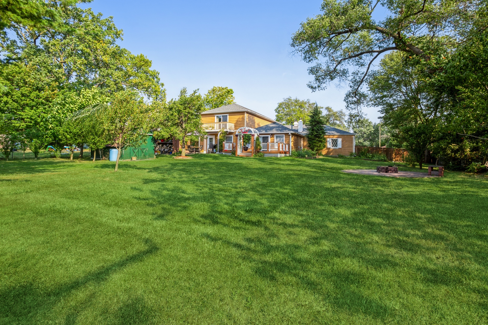 613 West Edgewood Road Lombard, IL 60148 - Photo 20 of 21 a view of a white house with a big yard and large trees
