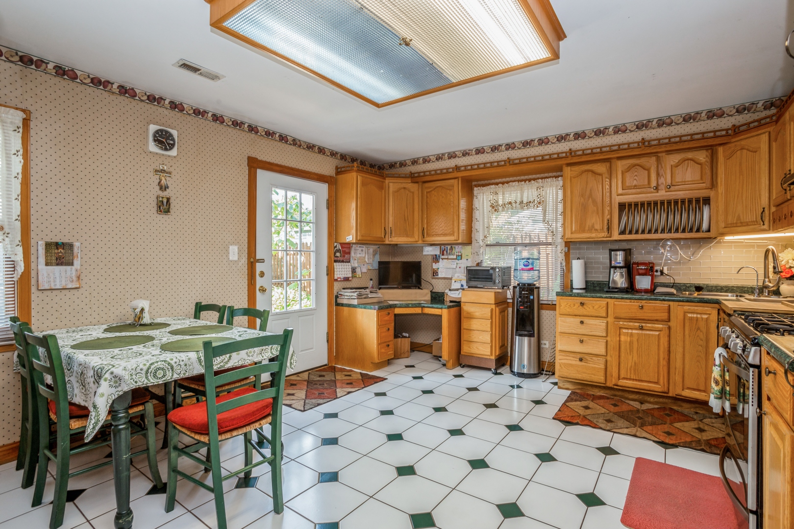 613 West Edgewood Road Lombard, IL 60148 - Photo 8 of 21 a kitchen with stainless steel appliances kitchen island granite countertop a sink and cabinets