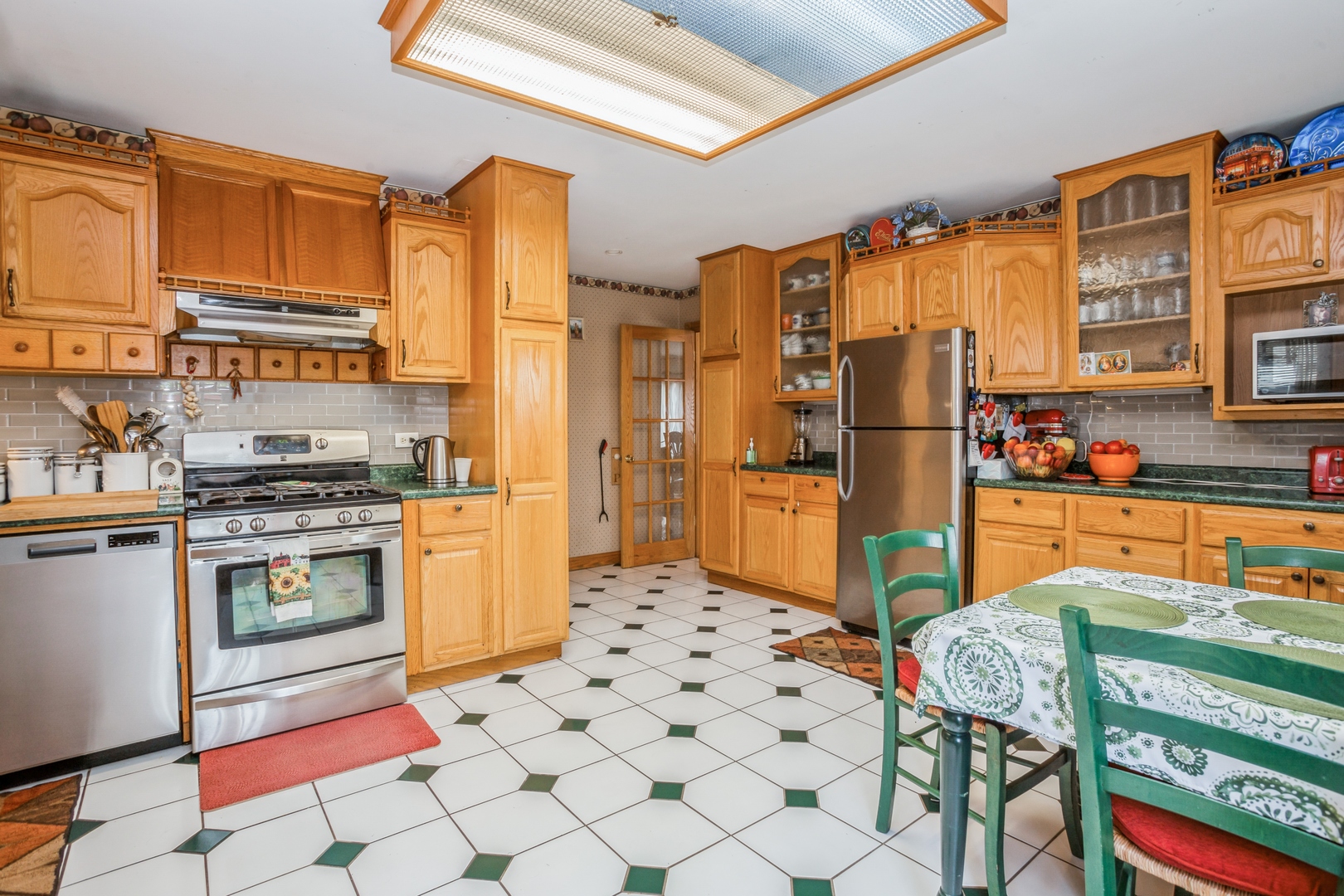 613 West Edgewood Road Lombard, IL 60148 - Photo 9 of 21 a kitchen with stainless steel appliances a refrigerator and a stove top oven