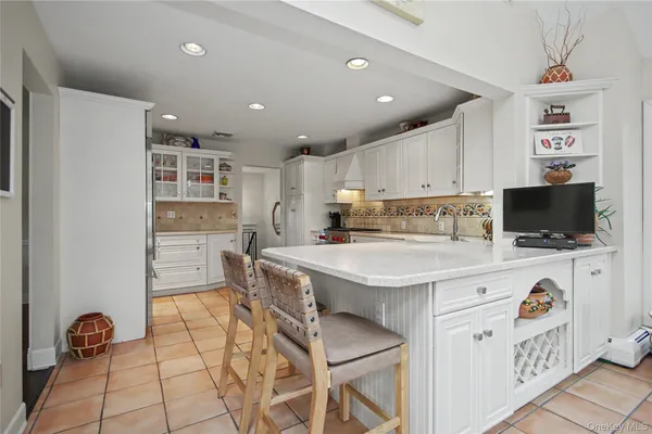 a kitchen with a stove a refrigerator and a cabinets
