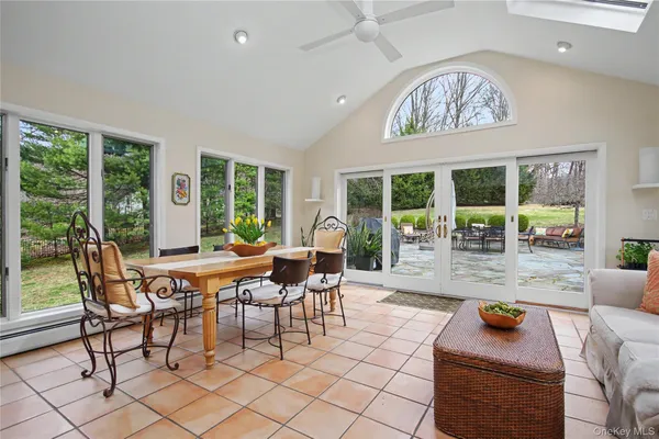 a dining room with furniture a rug and a large window